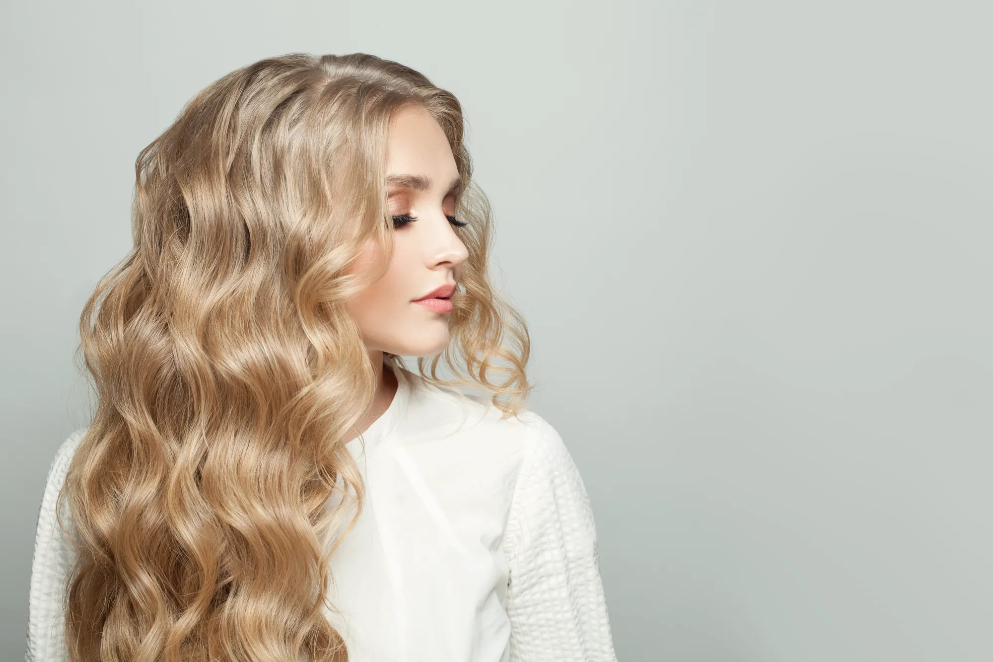 Long blonde waves after a color and styling service at a Charleston, WV salon